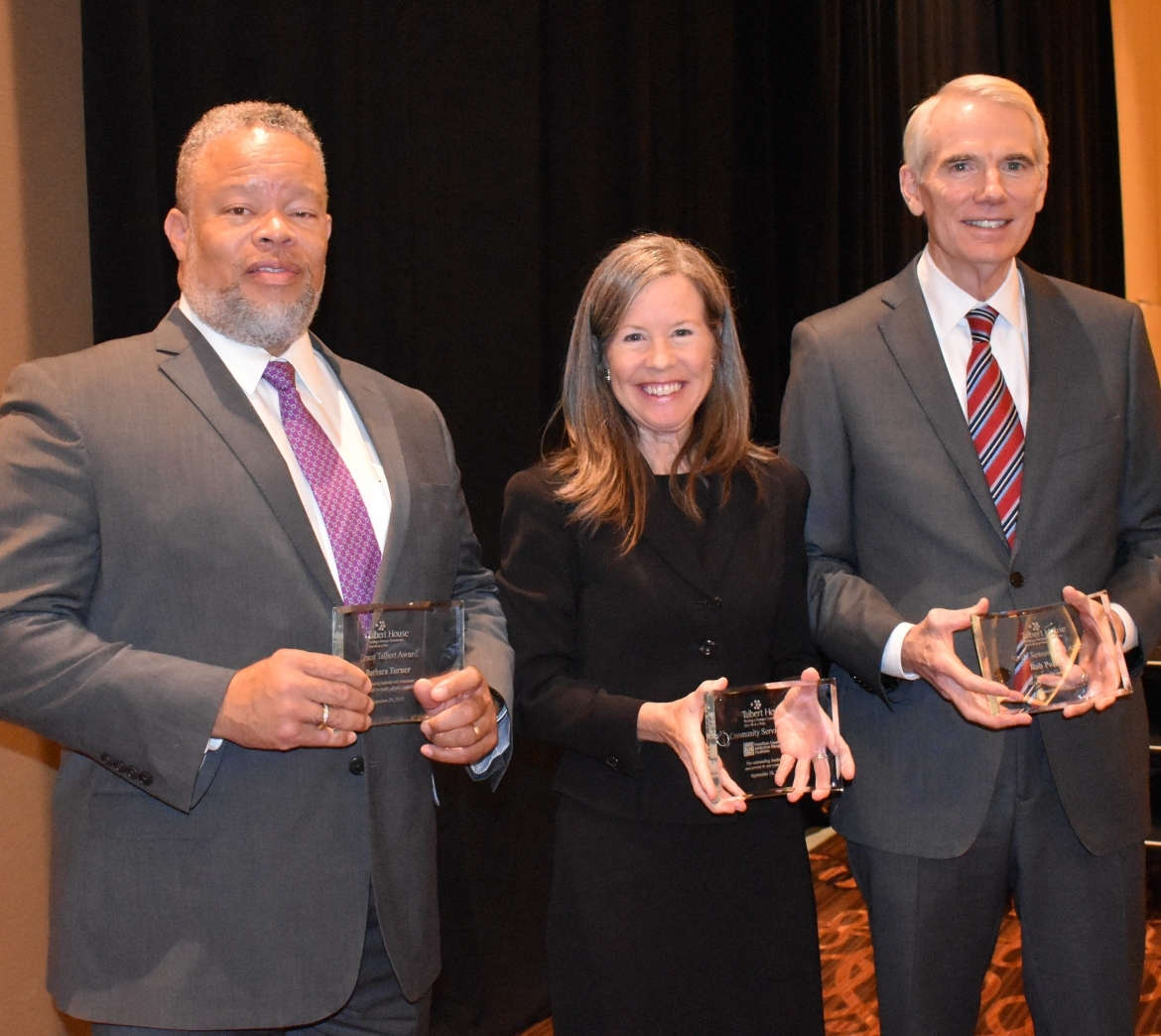 Three people with awards